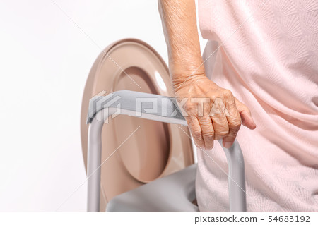 Elderly woman using mobile toilet seat chair Elderly woman using mobile toilet seat chair 54683192