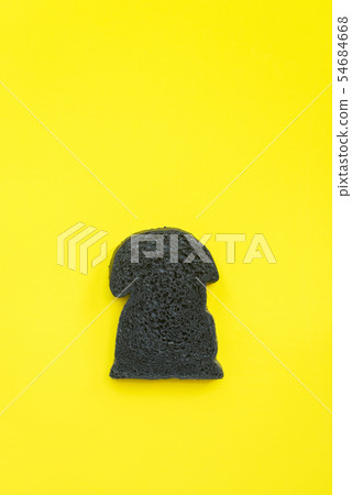 Organic bio charcoal bread on yellow background Organic bio charcoal bread on yellow background 54684668
