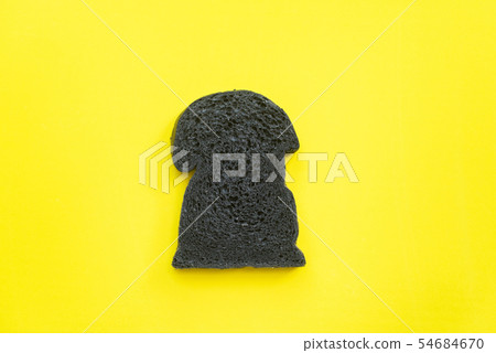 Organic bio charcoal bread on yellow background Organic bio charcoal bread on yellow background 54684670