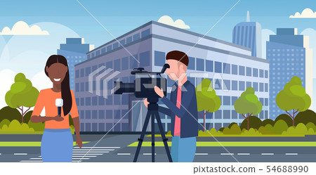 reporter man with woman journalist presenting live news operator using video camera on tripod 54688990
