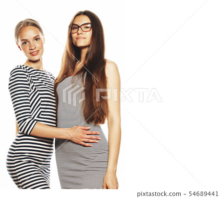 two young workers isolated on white, same dresses in strip two young workers isolated on white, same dresses in strip 54689441