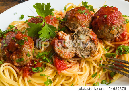 Pasta and meatballs with mozzarella inside 54689876