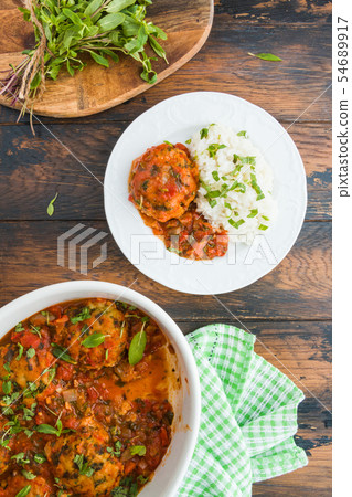 Fish rissoles  in spicy tomato sauce 54689917