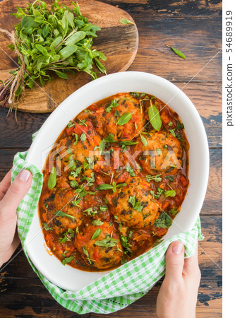 Fish rissoles  in spicy tomato sauce 54689919