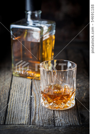 Glass and a bottle of whiskey 54691188