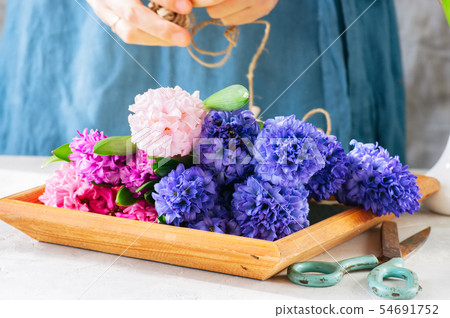 Florist girl gathering bouquet of hyacinth Florist girl gathering bouquet of hyacinth 54691752