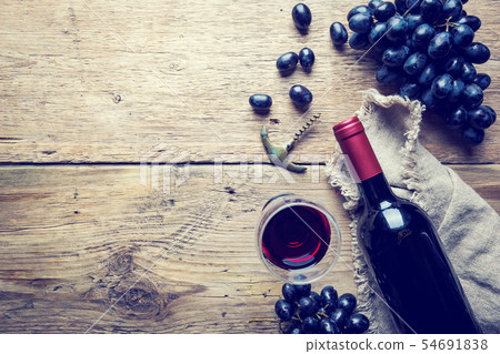 A bottle of red wine with grapes A bottle of red wine with grapes 54691838