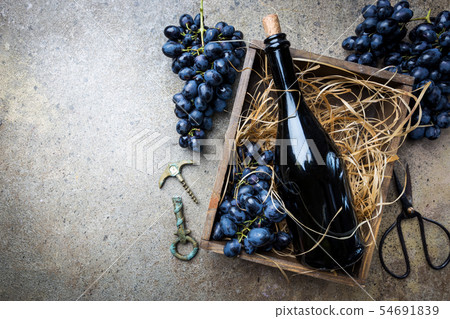 A bottle of red wine with grapes A bottle of red wine with grapes 54691839