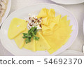 Sliced hard cheese on a plate 54692370