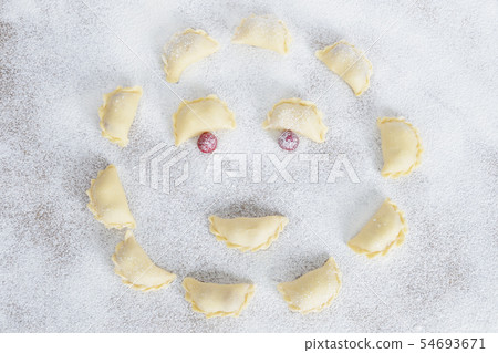 The raw traditional Ukrainian hand-made vareniki The raw traditional Ukrainian hand-made vareniki 54693671
