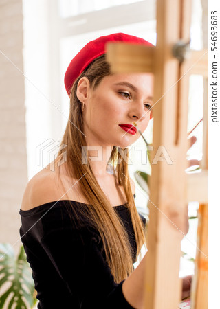 Attractive artist girl with long hair in red beret 54693683