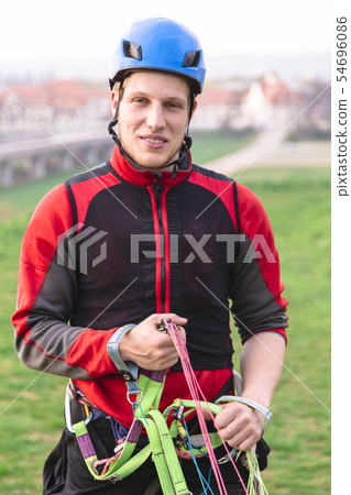 Young parachutist holding parachute slings and Young parachutist holding parachute slings and 54696086