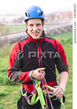 Young parachutist holding parachute slings and 54696087