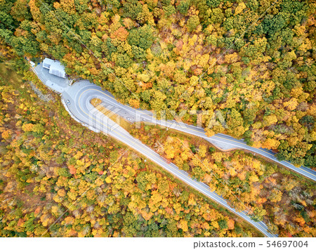 Scenic highway hairpin turn in autumn 54697004