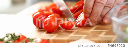 Male Hands Slicing Ripe Cherry Tomato Ingredient 54698020