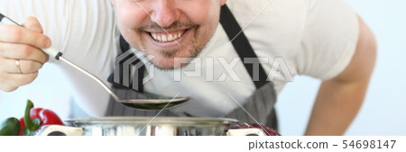 Satisfied Culinary Chef Holding Kitchen Spoon 54698147