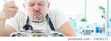 Professional Chef Blowing Metal Kitchen Spoon 54698171