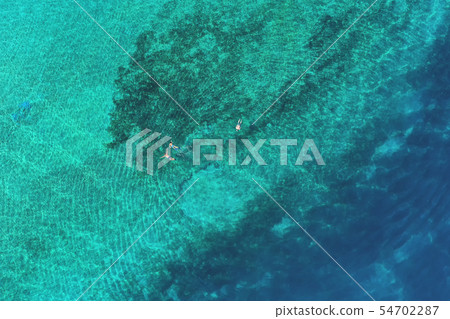 Father and son snorkels through tropical water Father and son snorkels through tropical water 54702287