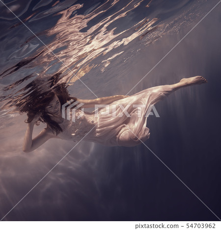 Portrait of a girl in a white dress under water Portrait of a girl in a white dress under water 54703962