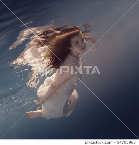 Portrait of a girl in a white dress under water 54703968