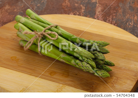 Raw asparagus heap 54704348