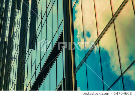 Sky with clouds reflected in windows of modern Sky with clouds reflected in windows of modern 54704668