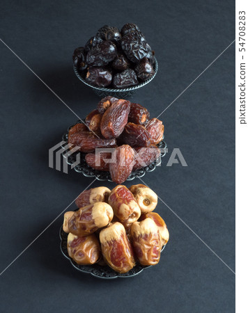 Arabic dates fruits are laid out on a dark table Arabic dates fruits are laid out on a dark table 54708283