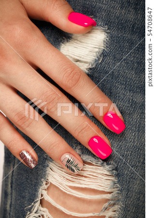 Bright neon manicure on female hands on the background of jeans. Nail design. Beauty hands. Bright neon manicure on female hands on the background of jeans. Nail design. Beauty hands. 54708647