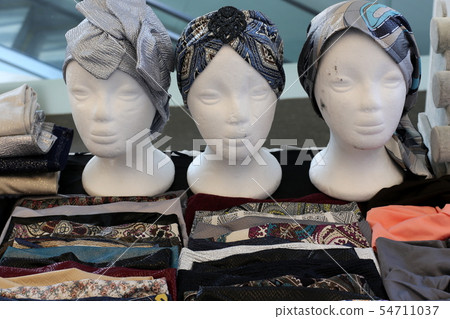 mannequin stands in a large store on a shop window 54711037