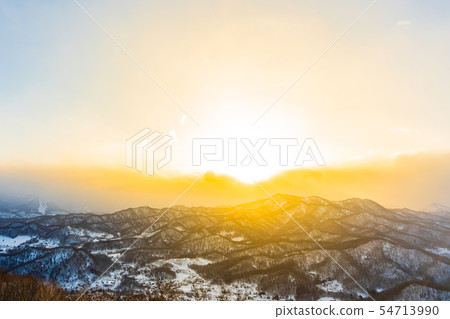 Beautiful landscape with mountain around tree in snow winter season at sunset time Beautiful landscape with mountain around tree in snow winter season at sunset time 54713990