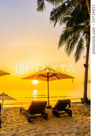 Umbrella and chair on the beautiful beach and sea at sunrise time for travel and vacation Umbrella and chair on the beautiful beach and sea at sunrise time for travel and vacation 54714857