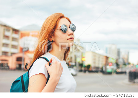 Attractive redhead smiling girl in sunglasses Attractive redhead smiling girl in sunglasses 54718155