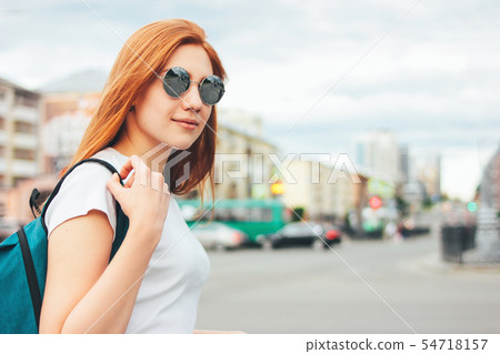 Attractive redhead smiling girl in sunglasses Attractive redhead smiling girl in sunglasses 54718157