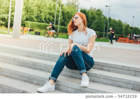 Attractive redhead smiling girl in round glasses Attractive redhead smiling girl in round glasses 54718159