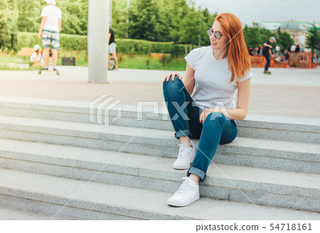 Attractive redhead smiling girl in round glasses 54718161