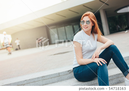 Attractive redhead smiling girl in round glasses Attractive redhead smiling girl in round glasses 54718163