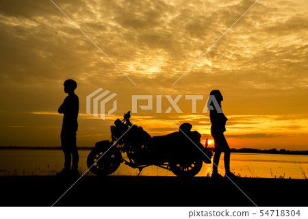 Silhouette woman riding motor bike with sunset. Silhouette woman riding motor bike with sunset. 54718304