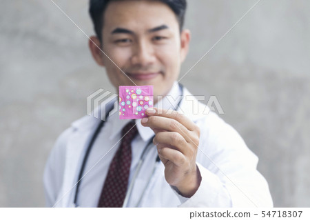 Handsome playboy showing condom on hand. Safe sex Handsome playboy showing condom on hand. Safe sex 54718307