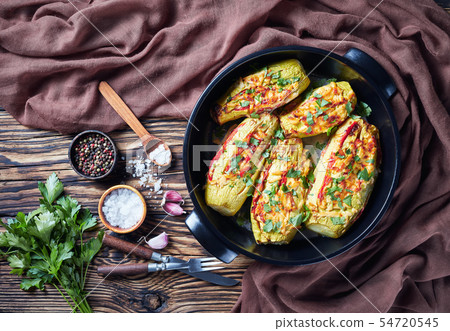 Stuffed courgettes with tomatoes sliced and cheese 54720545