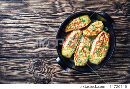 Stuffed courgettes with tomatoes sliced and cheese Stuffed courgettes with tomatoes sliced and cheese 54720546