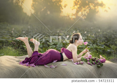 woman harvesting water lilies woman harvesting water lilies 54723311