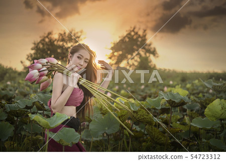 woman harvesting water lilies woman harvesting water lilies 54723312