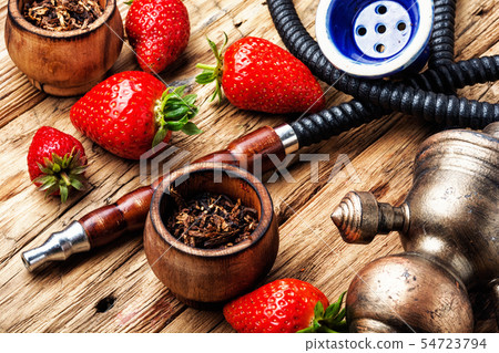 Smoking hookah on strawberry Smoking hookah on strawberry 54723794