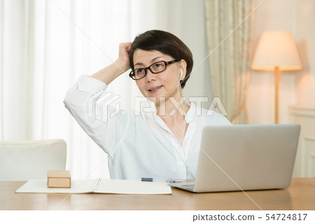 Middle woman doing home work 54724817
