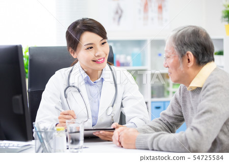 Female doctor see elder patient Female doctor see elder patient 54725584