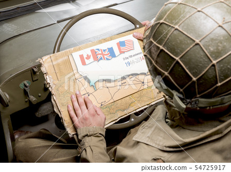 driver of a military vehicle look at a map of 54725917
