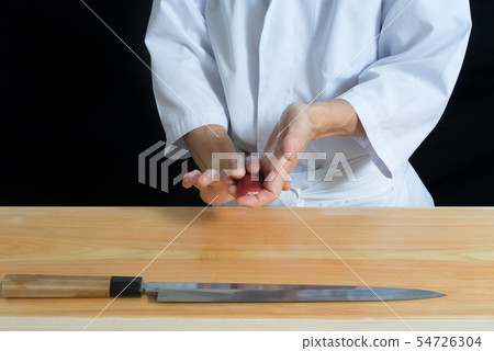 Imazen holding tuna sushi Imazen holding tuna sushi 54726304