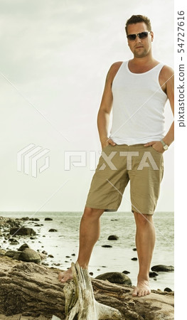 Fashion portrait of handsome man on the beach Fashion portrait of handsome man on the beach 54727616