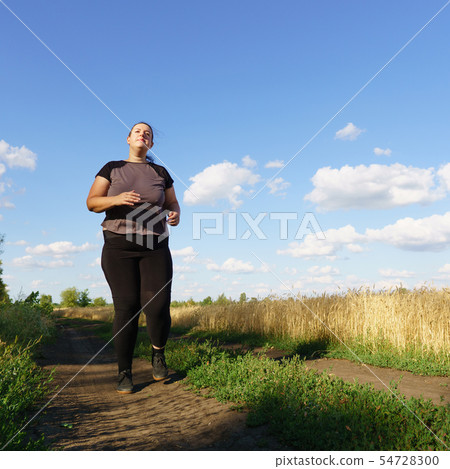 Overweight runner go jogging outdoors. Weight loss Overweight runner go jogging outdoors. Weight loss 54728300