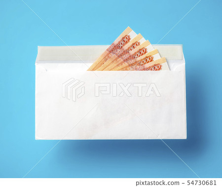 White envelope with cash ruble banknotes on blue White envelope with cash ruble banknotes on blue 54730681